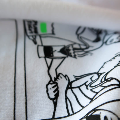 A close up of the illustration on the Plain Sight Story Shirt