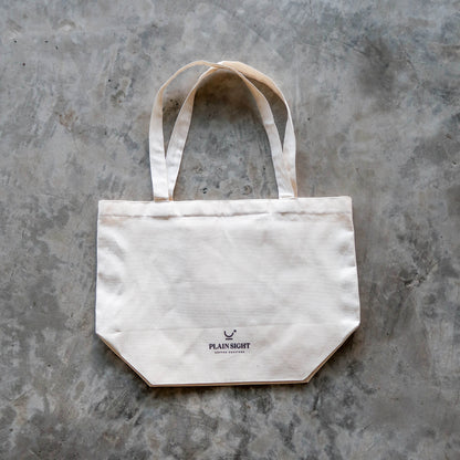 The Plain Sight Story Tote from the front, laid flat