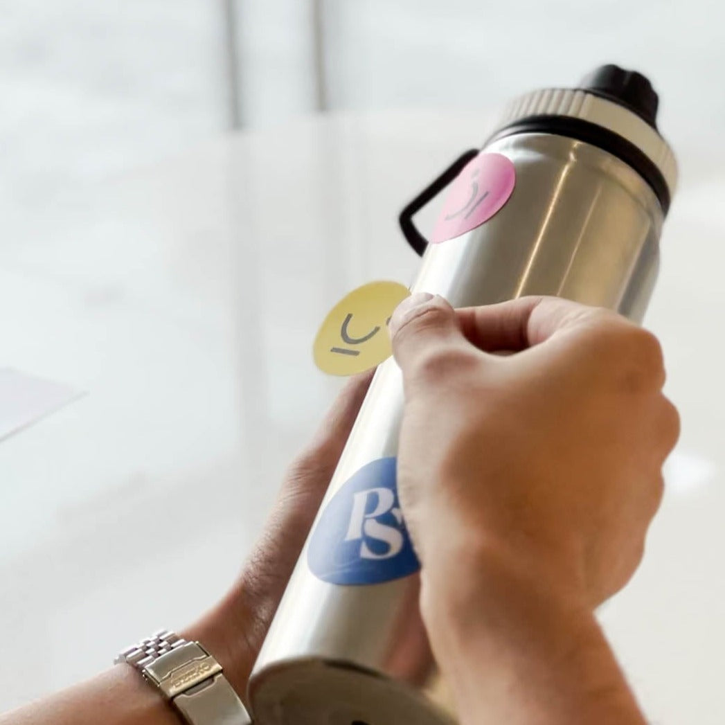 Plain Sights's logo stickers displayed on a tumbler